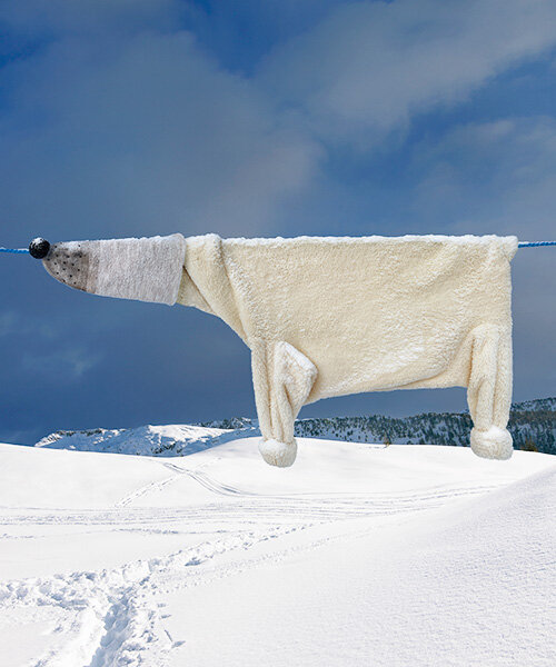helga stentzel hangs a clothes polar bear to raise awareness on climate change