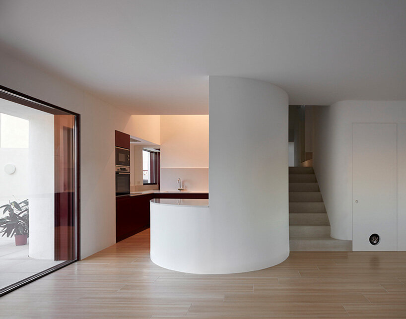 brick plinth contrasts with concrete curved mass in horma estudio's casa AA in spain