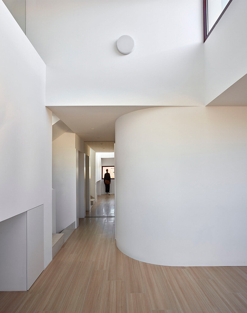 brick plinth contrasts with concrete curved mass in horma estudio's casa AA in spain