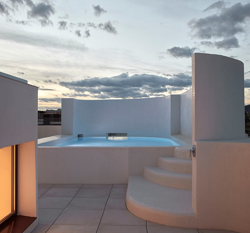 brick plinth contrasts with concrete curved mass in horma estudio's casa AA in spain