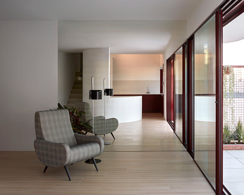 brick plinth contrasts with concrete curved mass in horma estudio's casa AA in spain