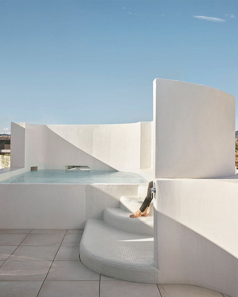 brick plinth contrasts with concrete curved mass in horma estudio's casa AA in spain