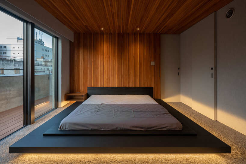 five-story atrium brings natural light into keitaro muto's concrete apartment building in japan