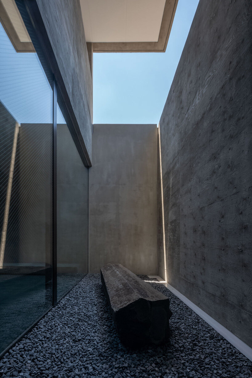 five-story atrium brings natural light into keitaro muto's concrete apartment building in japan