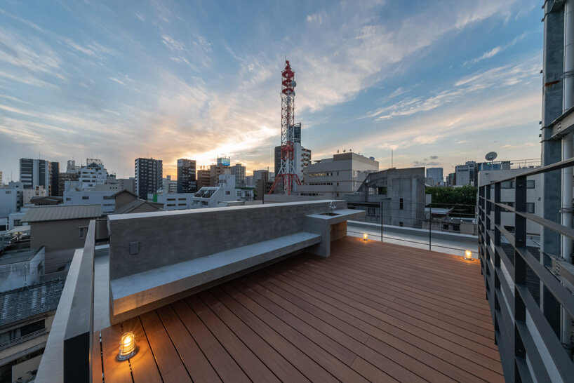 five-story atrium brings natural light into keitaro muto's concrete apartment building in japan
