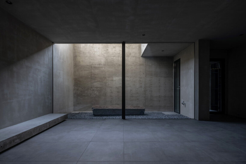 five-story atrium brings natural light into keitaro muto's concrete apartment building in japan