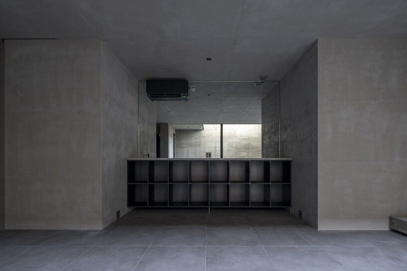 five-story atrium brings natural light into keitaro muto's concrete apartment building in japan