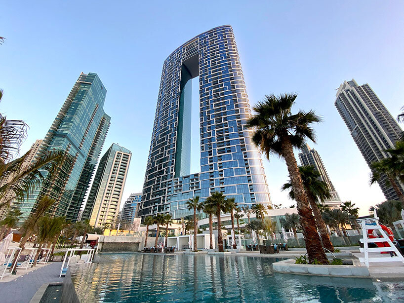 killa design tops 'address' beach resort towers with bridging infinity pool