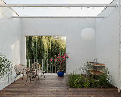 MFRMGR inserts cutout terraces to cuboid concrete house settling within polish village