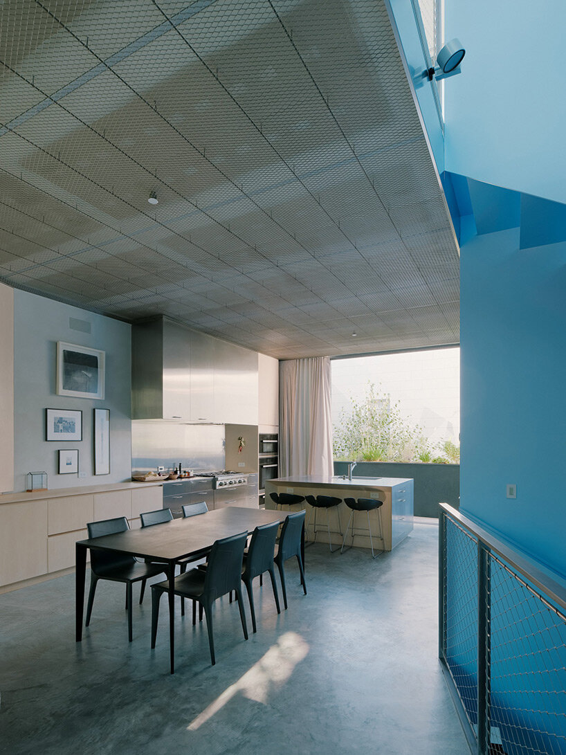 vibrant blue interior peeks through dense facade in san fransisco 'hidden house' by OPA