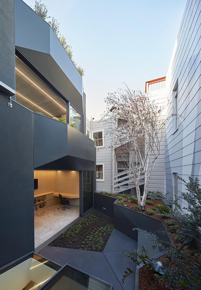 vibrant blue interior peeks through dense facade in san fransisco 'hidden house' by OPA