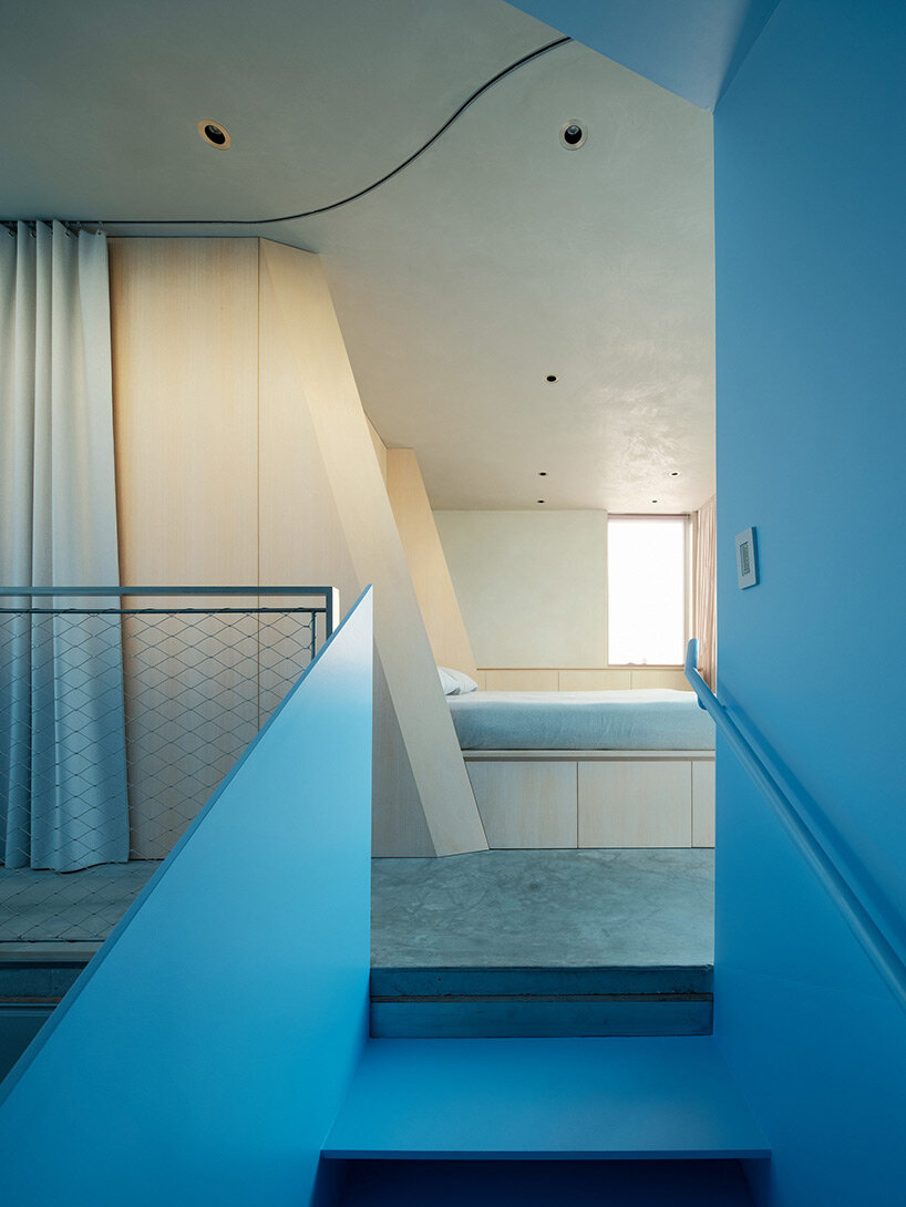 vibrant blue interior peeks through dense facade in san fransisco 'hidden house' by OPA