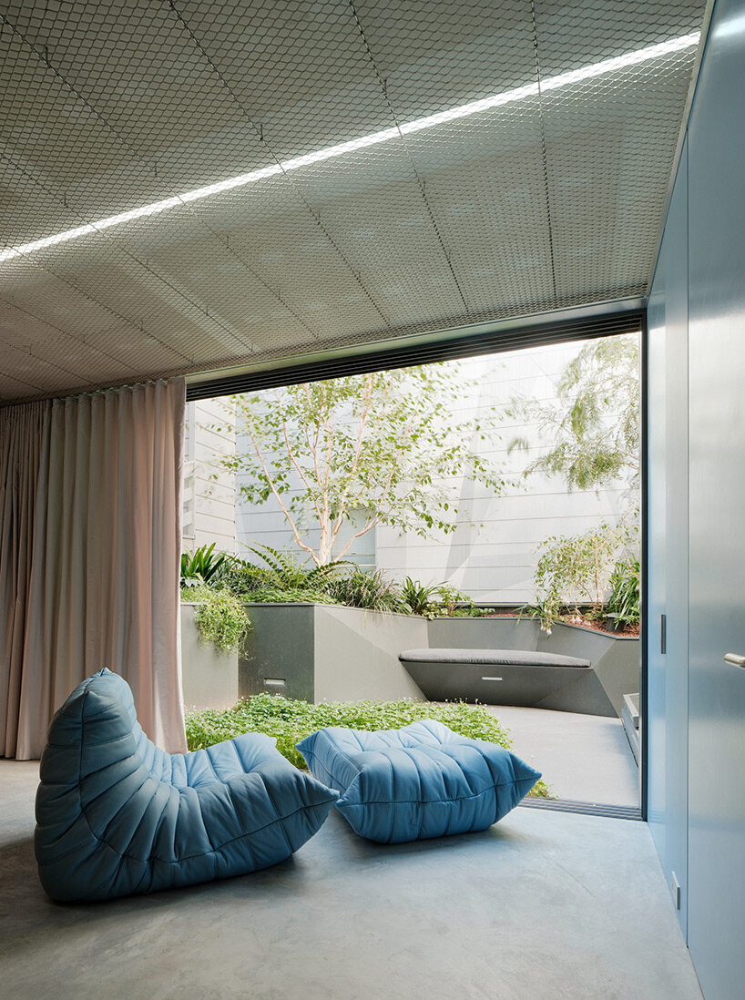 vibrant blue interior peeks through dense facade in san fransisco 'hidden house' by OPA