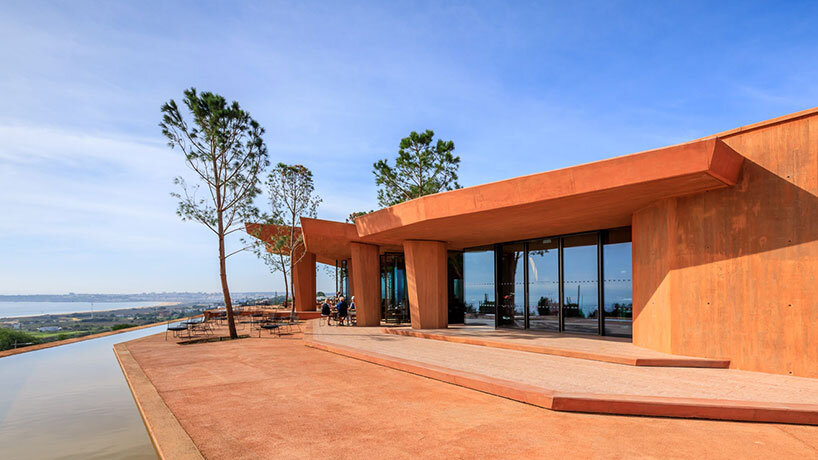 RCR arquitectes' palmares clubhouse in algarve suggests tectonic plates of red concrete