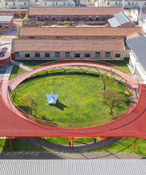 playful red platform encircles renovated youth activity center in china