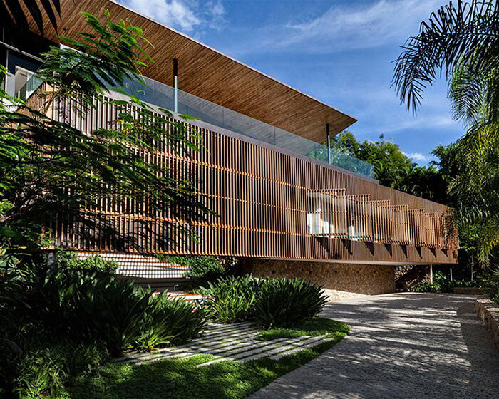 timber lattice with pivoting windows clads 'delta house' by bernardes arquitetura in brazil