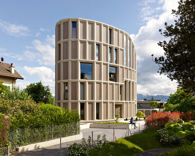curved residential building by LOCALARCHITECTURE favors views of lake geneva, switzerland