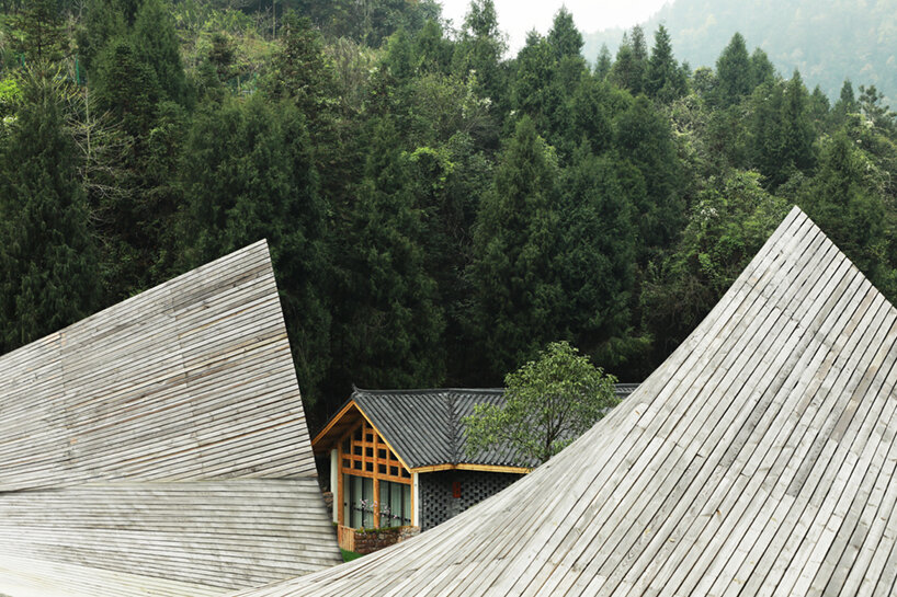 202 village guesthouses emerge from forested hunan as a group of mountainous peaks
