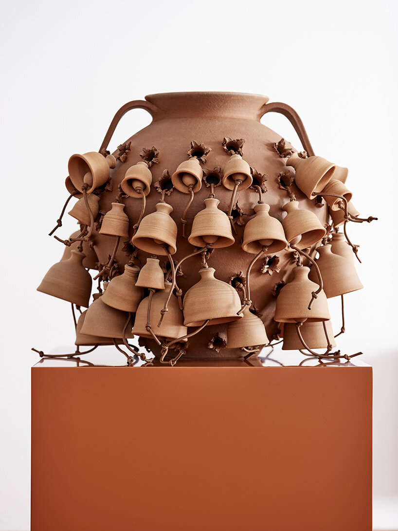 eyes, tongues, flowers and knots emerge from punctured terracotta pots in LOEWE weaves collection