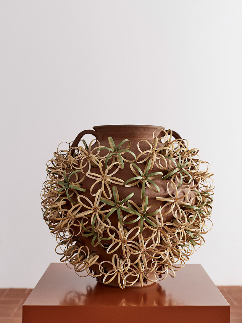 eyes, tongues, flowers + knots emerge from punctured pots in