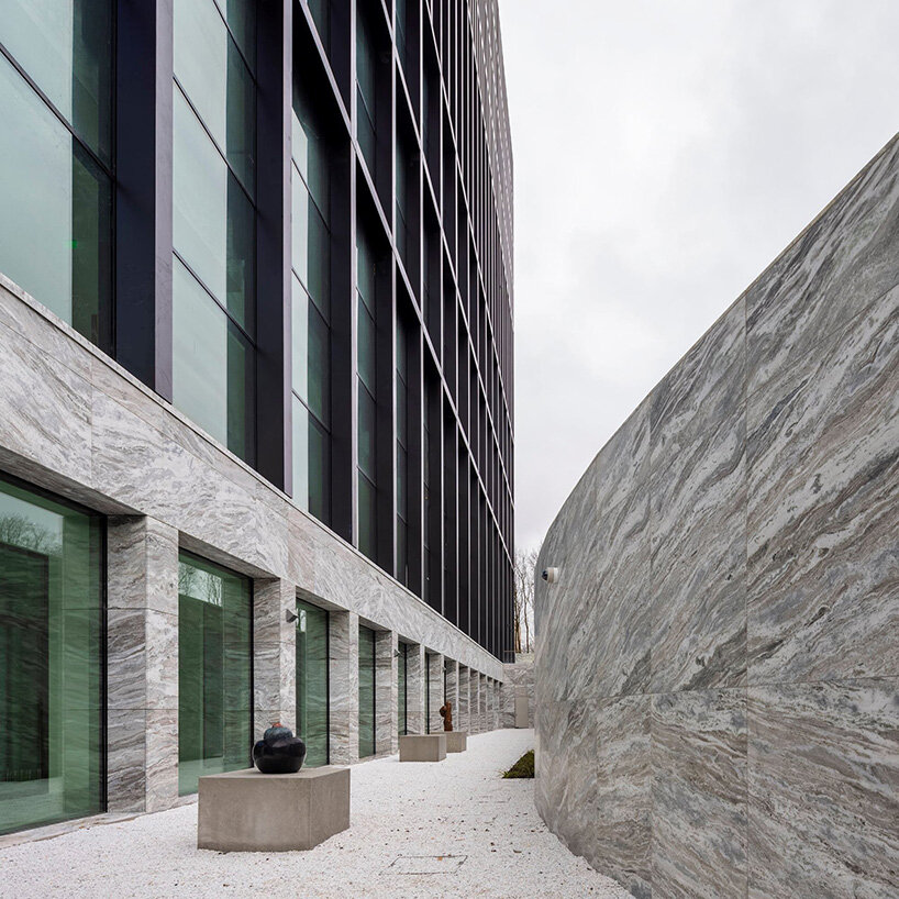 circular staircase spirals within the largest courthouse in the netherlands by KAAN