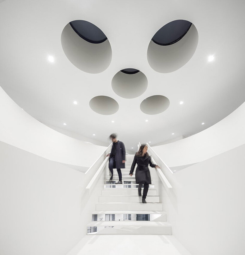 circular staircase spirals within the largest courthouse in the netherlands by KAAN
