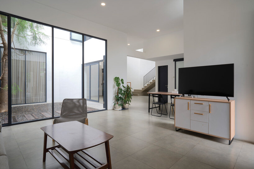 brick-clad façade of 'griyoase' house hides tree-planted courtyard in indonesia