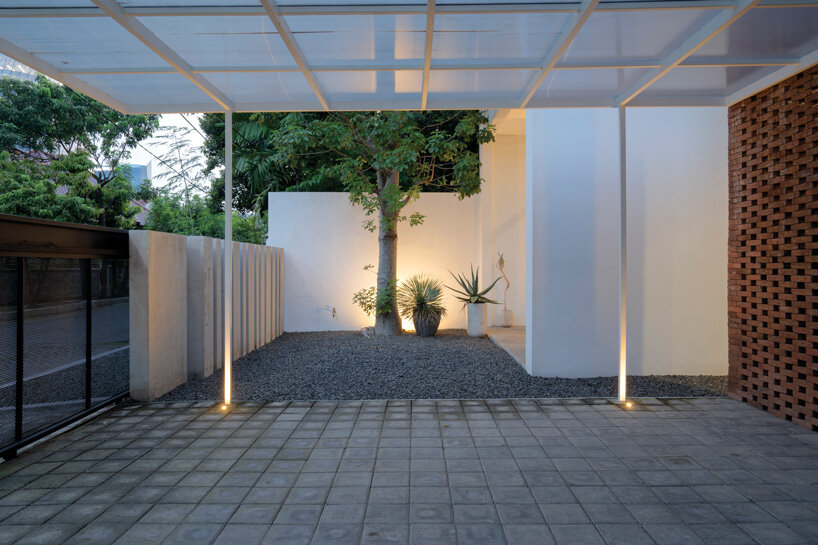 brick-clad façade of 'griyoase' house hides tree-planted courtyard in indonesia