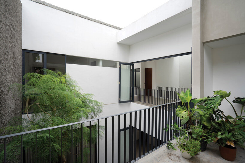brick-clad façade of 'griyoase' house hides tree-planted courtyard in indonesia