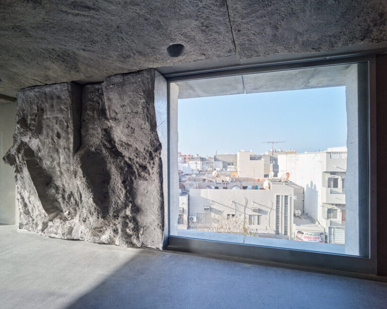 sandcasted concrete façade clads anne holtrop's green corner building