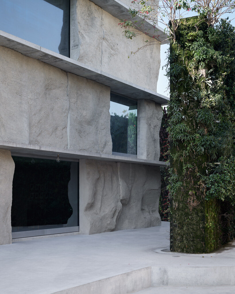 sand-casted concrete façade clads anne holtrop's green corner building in  bahrain