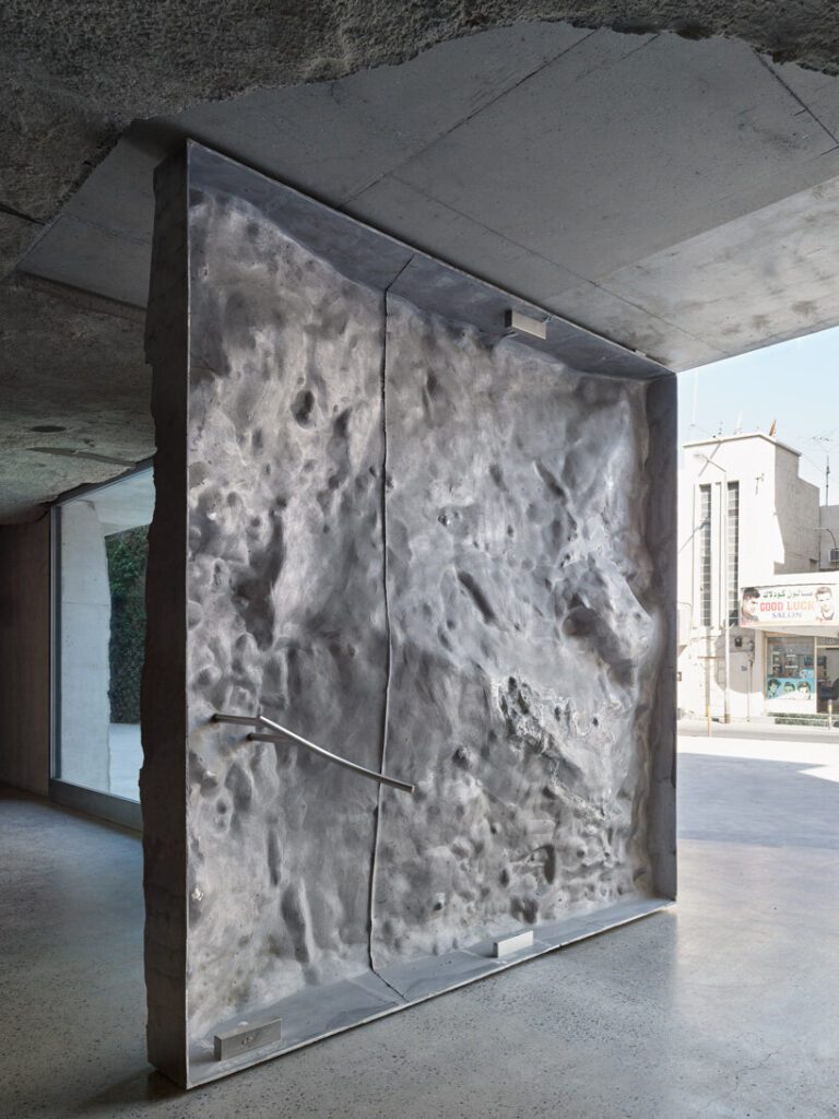 sandcasted concrete façade clads anne holtrop's green corner building