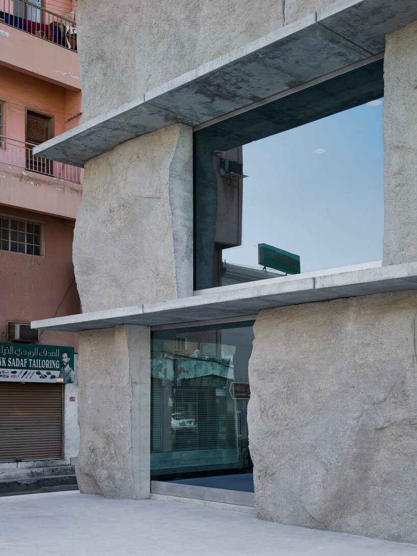 sand-casted concrete façade clads anne holtrop's green corner building in  bahrain