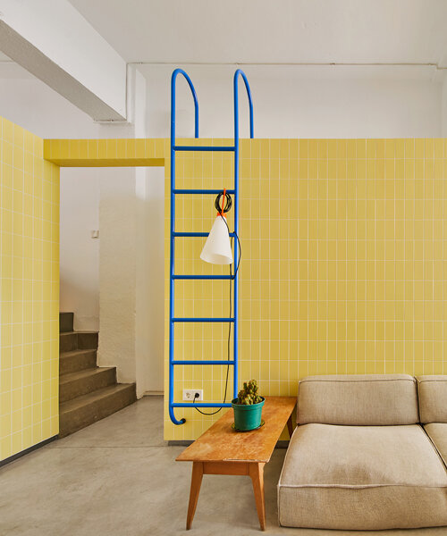 yellow tiled walls echo the previous use of a warehouse turned apartment in madrid
