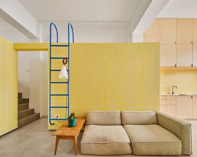 yellow tiled walls echo the previous use of a warehouse turned apartment in madrid