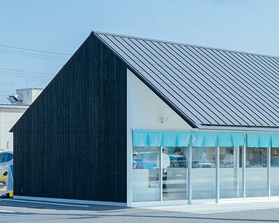 diagonal glass façade slices a laboratory-like sweet shop in maebashi, japan