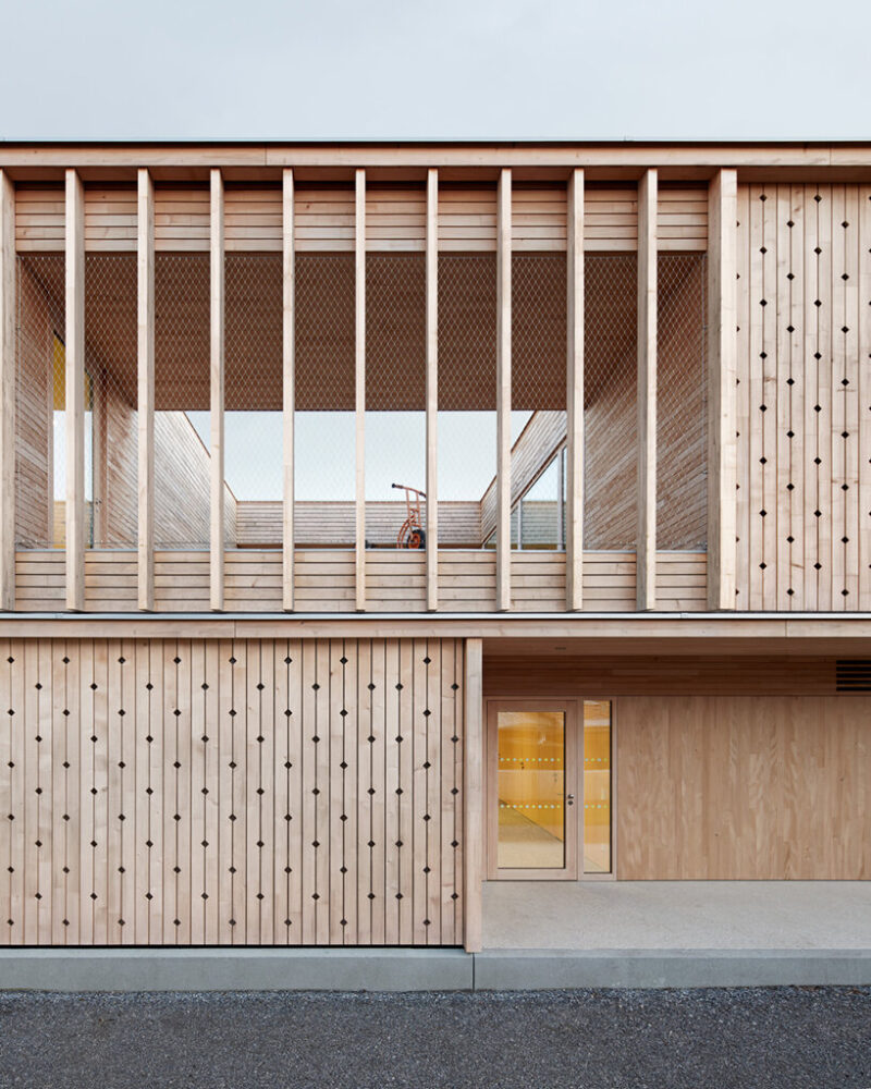 innauer matt's kindergarten engelbach is wrapped in delicate timber facade