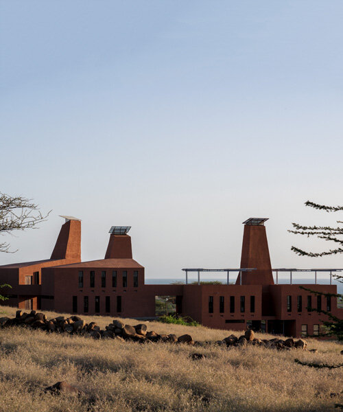tall ventilation towers in kéré architecture's kenyan education campus mimic termite mounds
