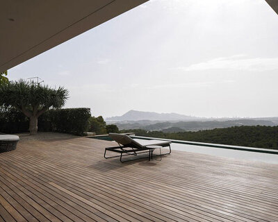 sloping 'casa toll' by RGB architects emerges from spanish mountainside