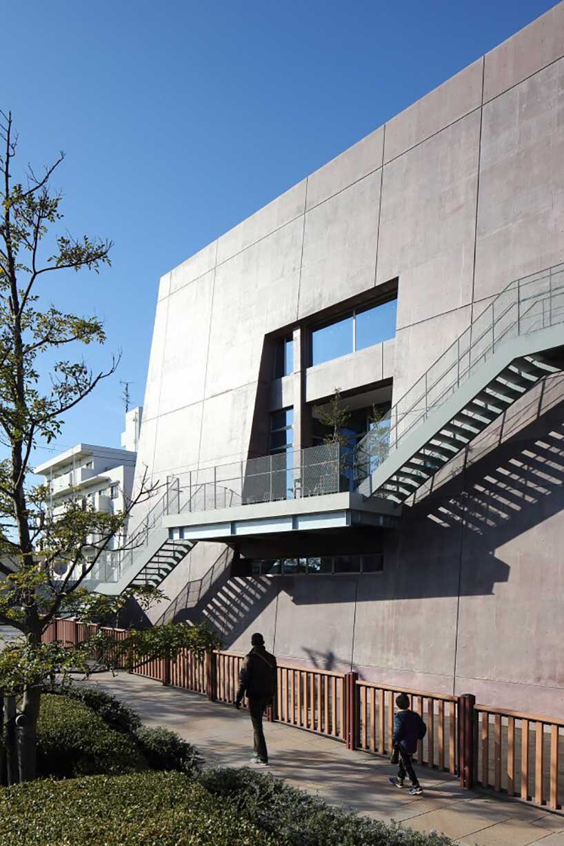 monolithic library extension by maru architecture floats on serene pond in matsubara, japan