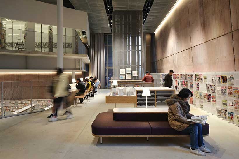 monolithic library extension by maru architecture floats on serene pond in matsubara, japan