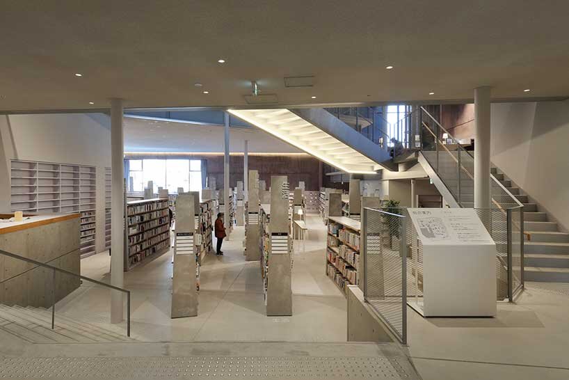 monolithic library extension by maru architecture floats on serene pond in matsubara, japan