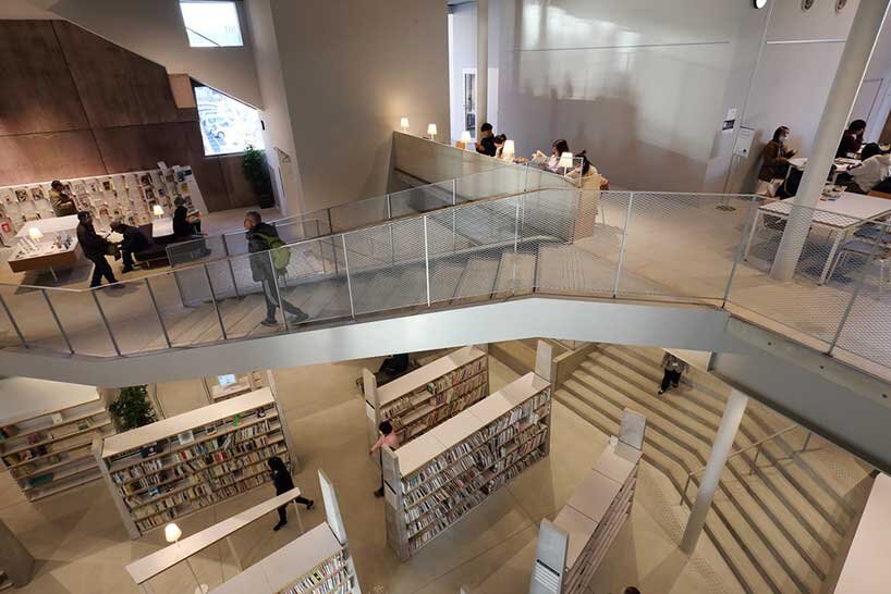 monolithic library extension by maru architecture floats on serene pond in matsubara, japan