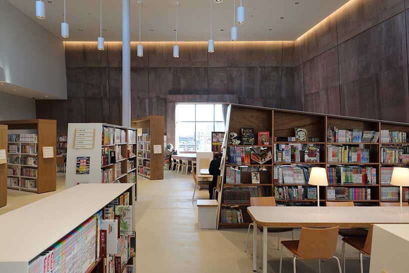 monolithic library extension by maru architecture floats on serene pond in matsubara, japan