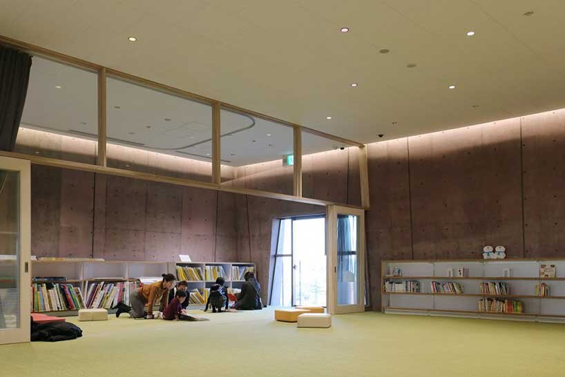monolithic library extension by maru architecture floats on serene pond in matsubara, japan
