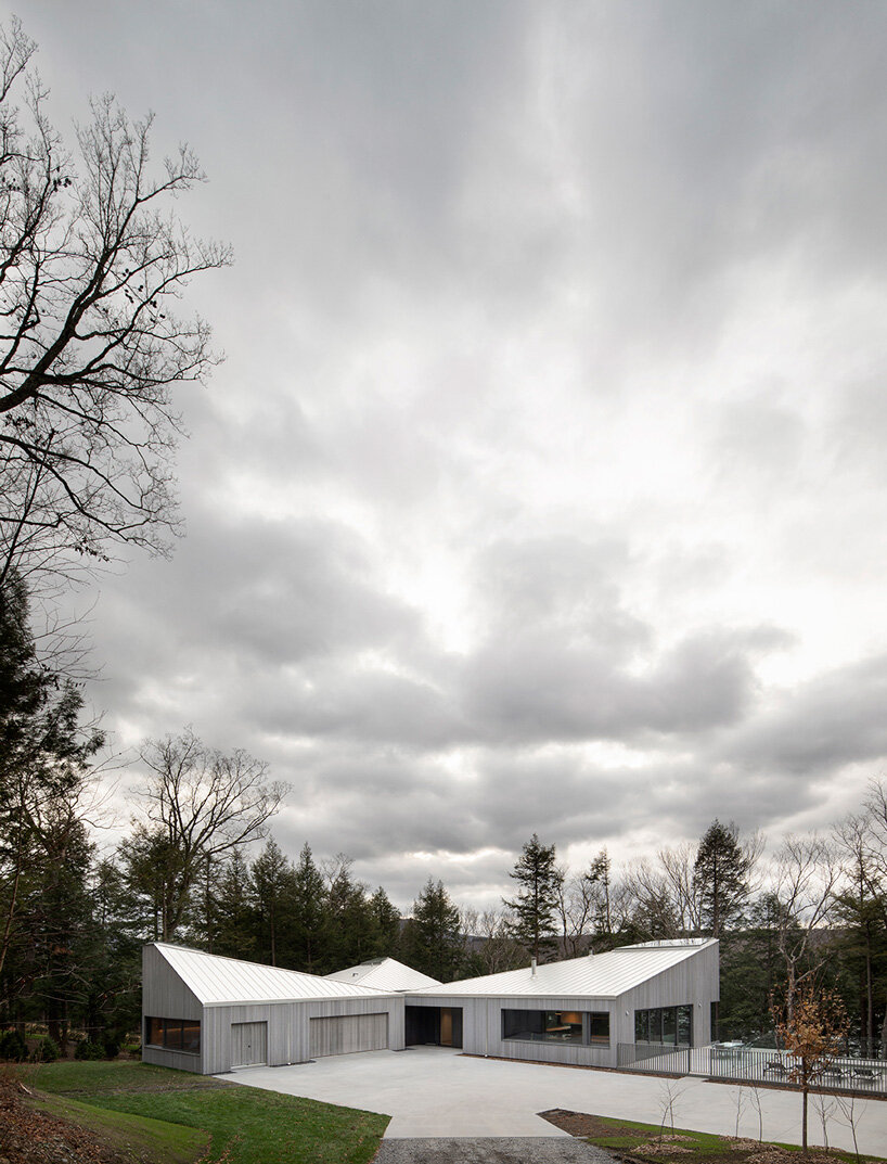 naturehumaine tops lake house in canada with sculptural slanted roofs + polygonal skylights