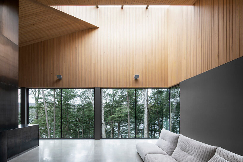 naturehumaine tops lake house in canada with sculptural slanted roofs + polygonal skylights