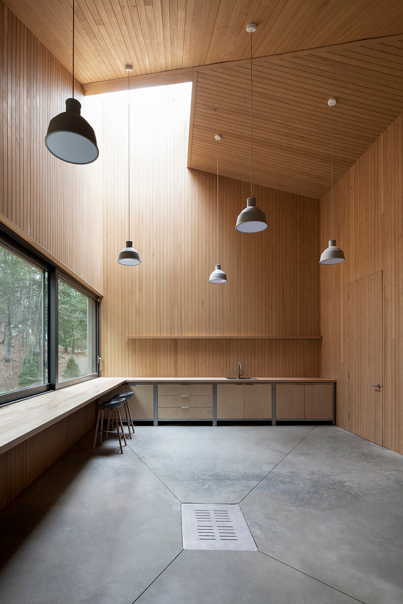 naturehumaine tops lake house in canada with sculptural slanted roofs + polygonal skylights