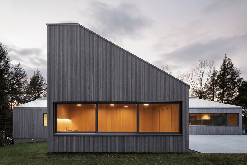 naturehumaine tops lake house in canada with sculptural slanted roofs + polygonal skylights