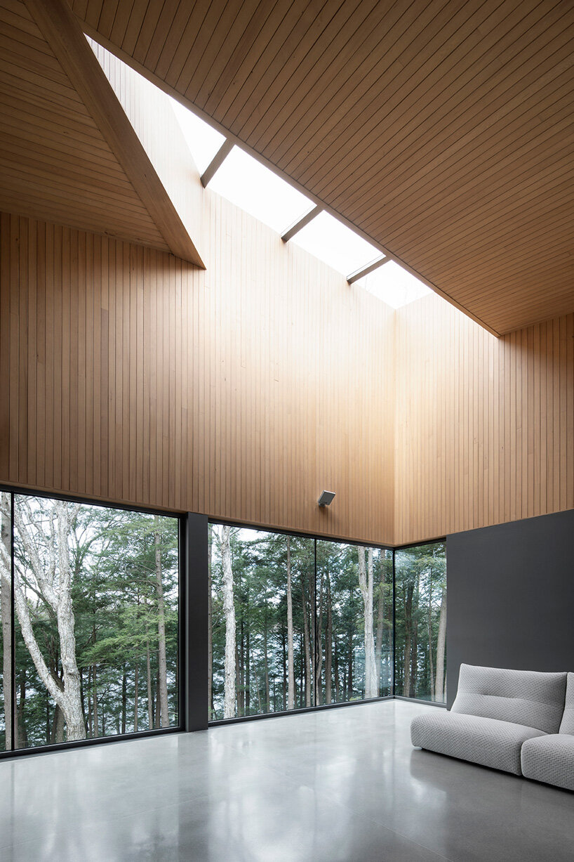 naturehumaine tops lake house in canada with sculptural slanted roofs + polygonal skylights